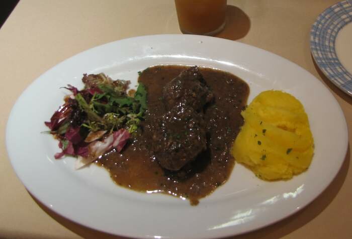 photo of Steak with salad and mashed potatoes entree